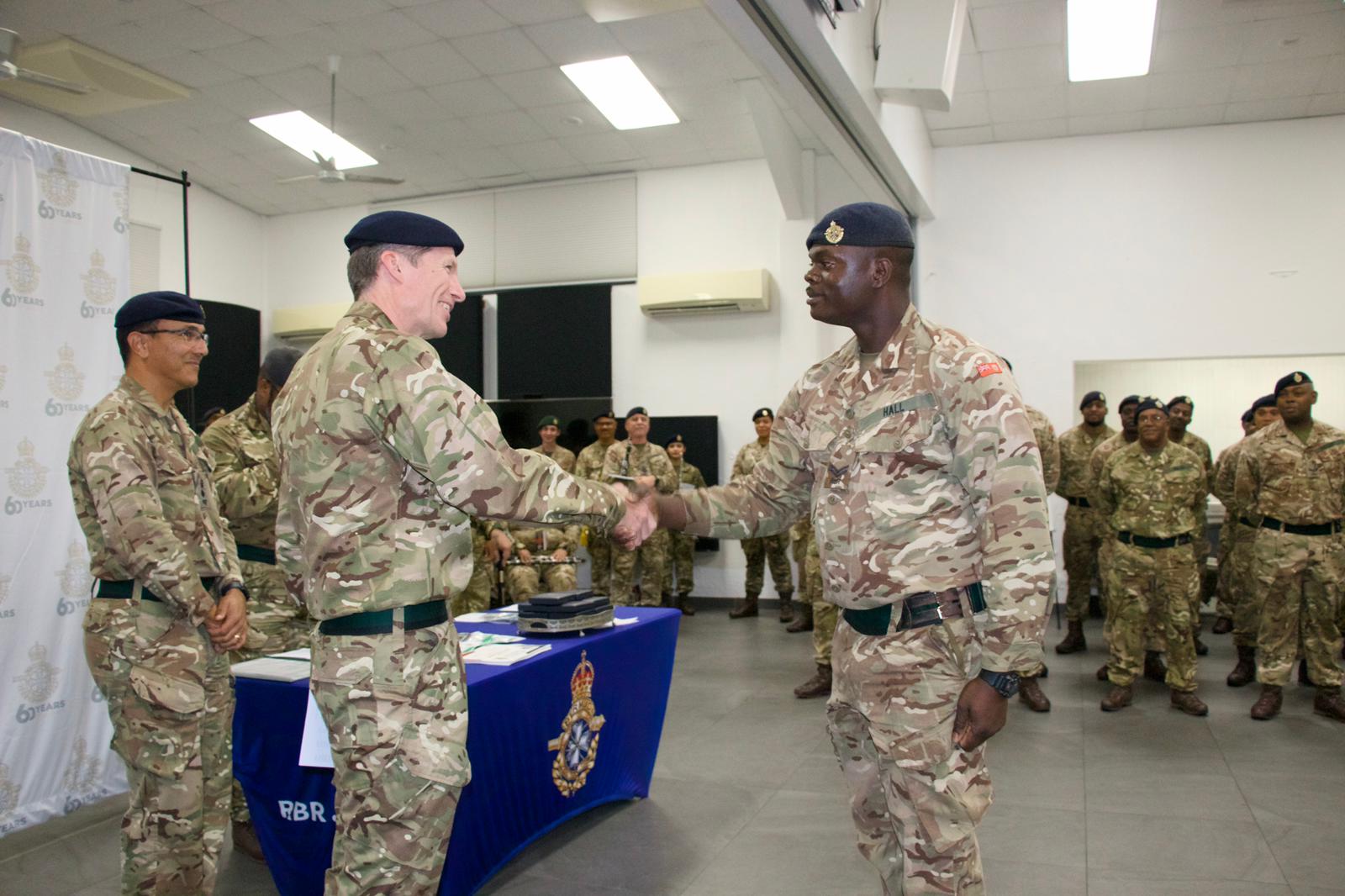 Governor Andrew Murdoch congratulates Sgt Orville Hall